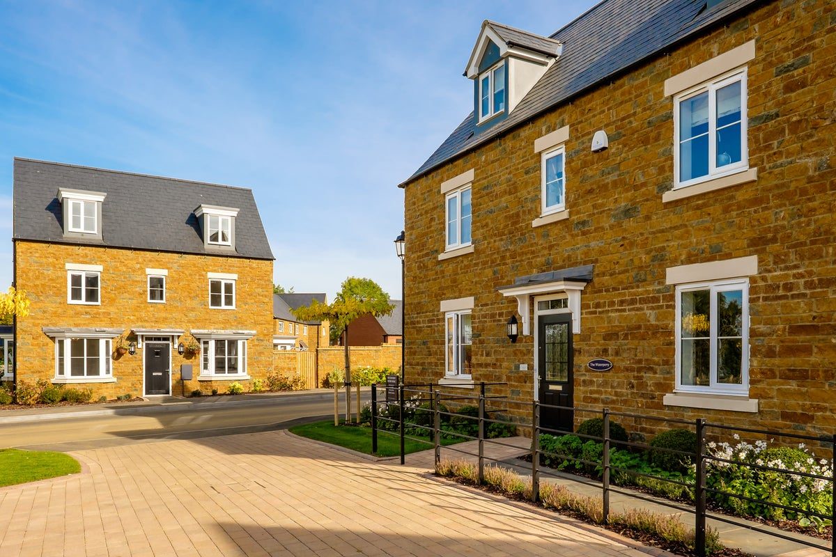 Britain’s biggest housebuilder slows land buying and cuts home sales outlook