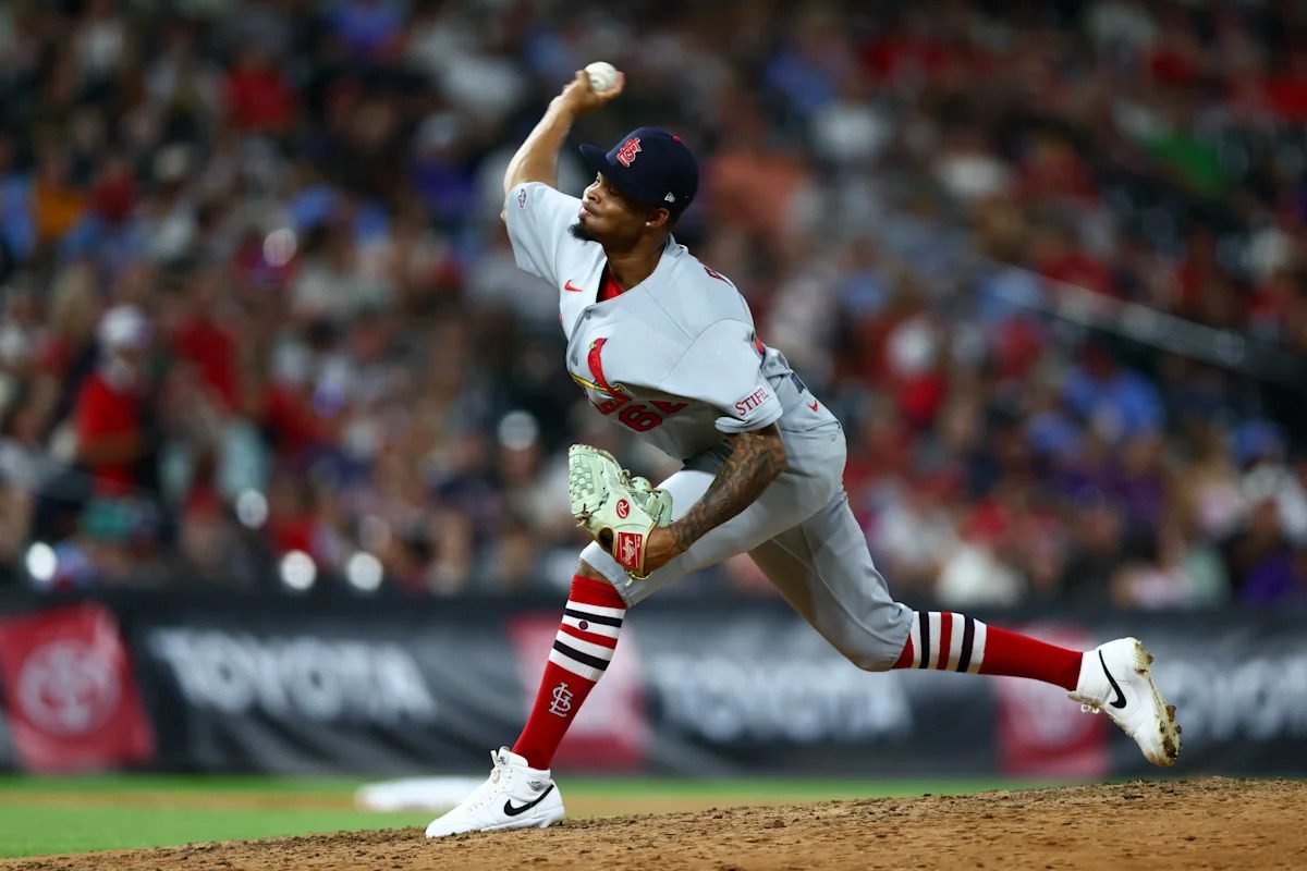 Cardinals players and staff wear crooked hats Saturday night after Friday's clash with umpire