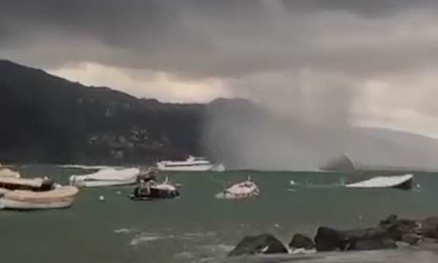 Moment giant water spout bears down on tourist boat in Italy as country is lashed with deadly flash floods and storms