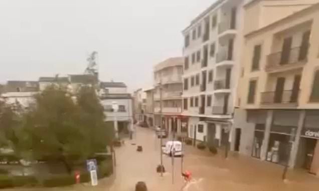 Woman drowns after falling over in a flooded street and getting trapped under a car as torrent rushed through in Majorca